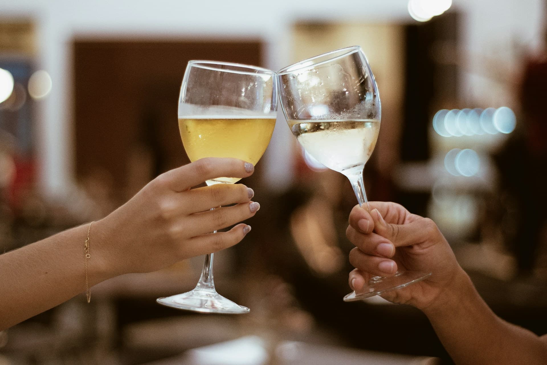 Two friends sharing a glass of wine over conversation